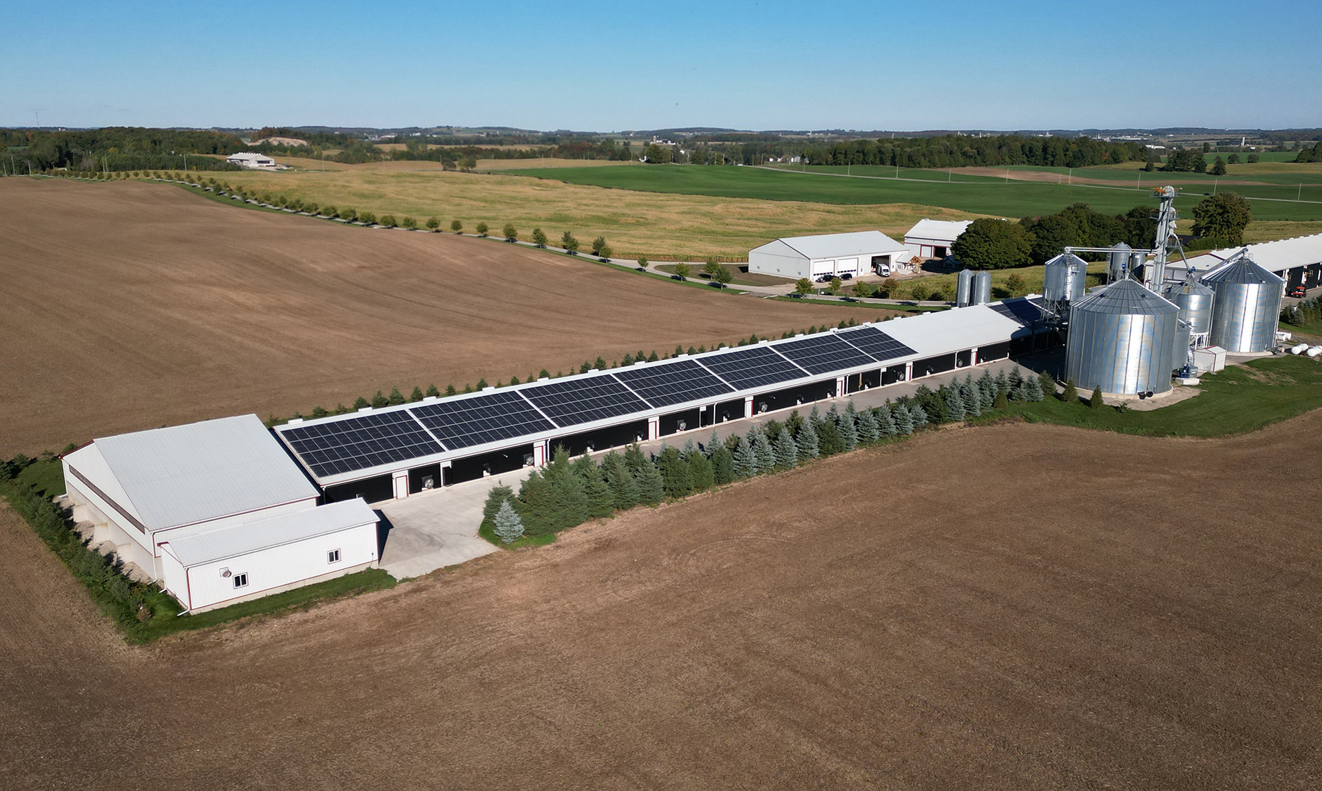 Overhead view of a farming facility with solar panels
